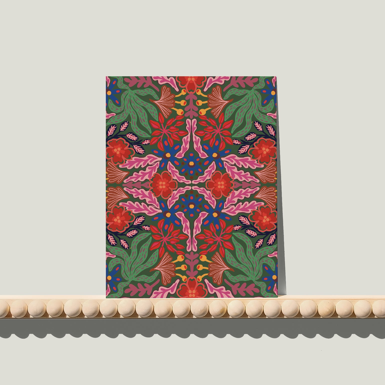 Enkele A6-kaart van Studio LilaLine met een symmetrische bloemenprint op de voorkant – het ontwerp bestaat uit spiegelende bloemvormen in groen, roze en blauw. De compositie voelt bijna als een vlinder of een inktvlektest: perfect in balans, met sierlijke lijnen die naar buiten toe uitwaaieren. De kleuren zorgen voor een frisse, dromerige uitstraling. De achterkant is leeg en klaar voor een handgeschreven boodschap.