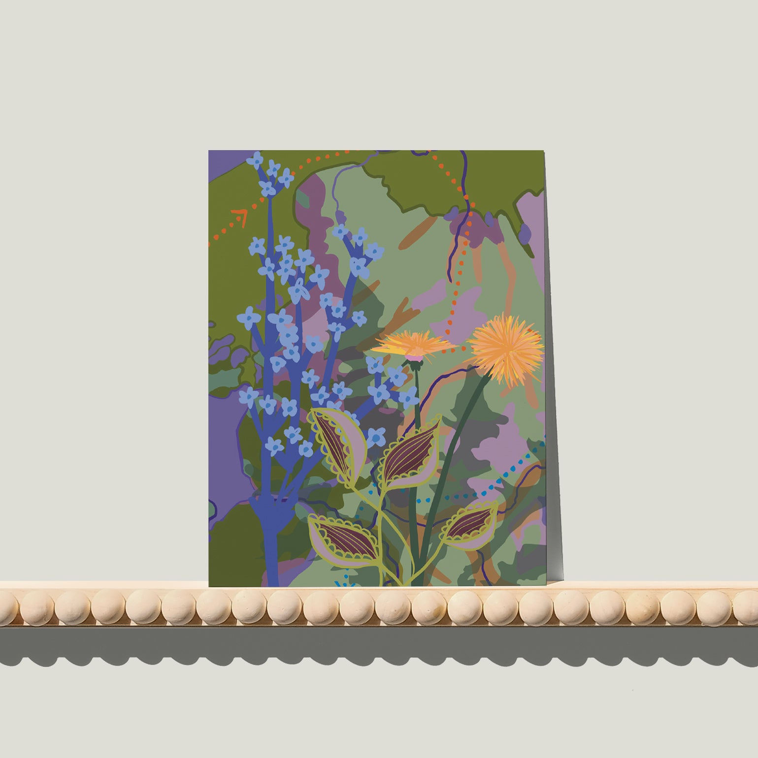 Enkele A6-kaart van Studio LilaLine met een gestileerde paardenbloemprint op de voorkant – het ontwerp toont een ronde, pluizige paardenbloem in tinten van groen, blauw en zacht geel. De fijne lijnen stralen naar buiten als een zonnetje vol zaden die elk moment kunnen wegwaaien. De compositie is licht en speels, met een frisse en natuurlijke uitstraling. De achterkant biedt ruimte voor een handgeschreven boodschap.