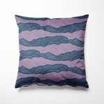 Kussen voor binnen en buiten met een golvend lijnenspel in diepblauw en paarsroze tinten. De abstracte print doet denken aan zee of landschap in beweging en geeft een rustige, moderne uitstraling aan je interieur of tuinmeubel. Gemaakt van sterke buitenstof – perfect voor binnen én buiten loungen.